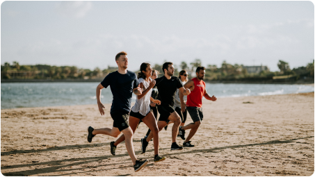 People running on a beach showing the activewear application of NOOSA™'s bio-based and recyclable fiber.