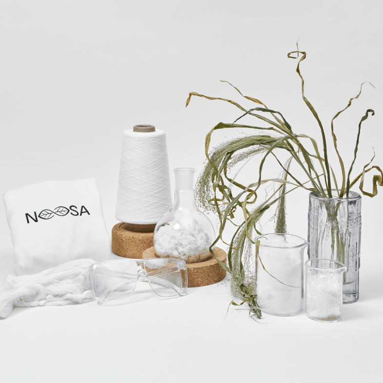 Different products that NOOSA™ is selling such as a white t-shirt, yarn, and recyclable fiber, other elements used in the process such as PLA pellets.