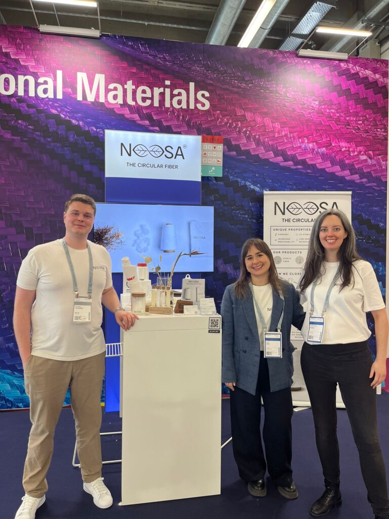 Niccoló, Luna and Emmanuelle, NOOSA™ team members in front of NOOSA™'s stand at Techtextil 2024.