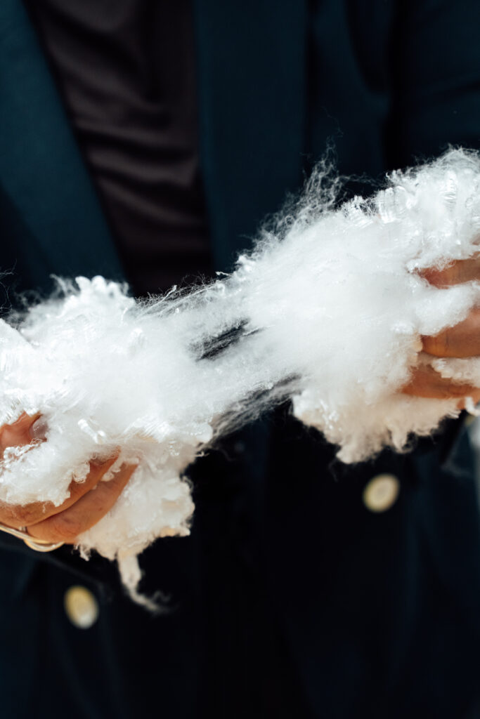 Women holding NOOSA® PLA fiber in her hands, seeing staple fibers like a cloud and coton